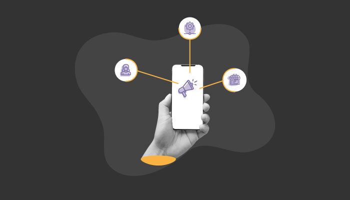 Ilustração: um mão segura um telefone com um megafone dentro, dela saem ícones relacionados ao marketing digital