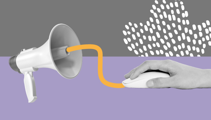 Uma mão segura um mouse. No outro lado do fio está conectado um megafone.