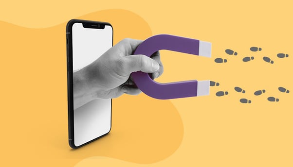 Ilustração: uma mão sai de dentro de um celular. Ela segura um ímã, que atrai passos, representando a atração de usuários.